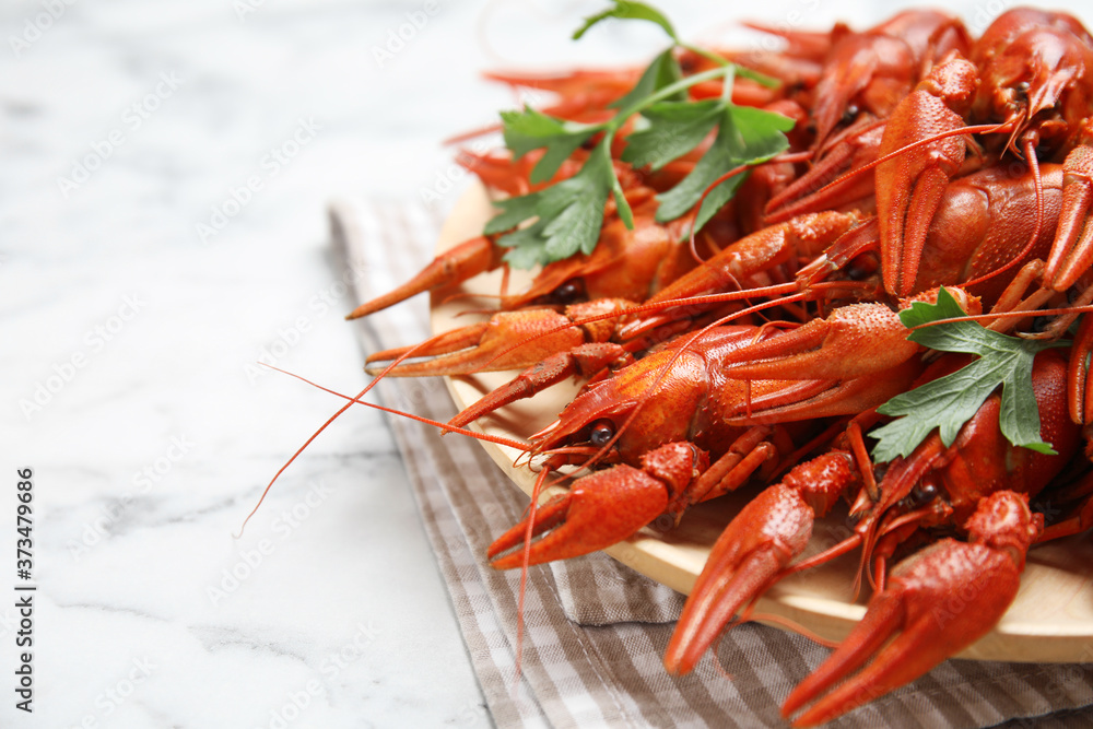 Delicious boiled crayfishes on white marble table, closeup. Space for text Delicious boiled crayfishes on white marble table, closeup. Space for text
