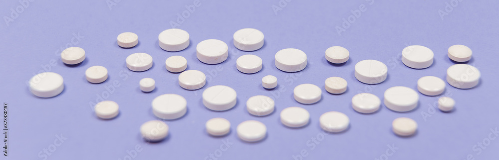 White pill on a purple background with copy space. White pill on a purple background with copy space.