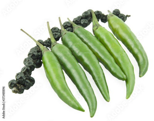 Green pepper chili and a black bell pepper photo