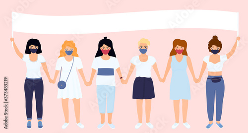 A young women in protective masks hold a poster. Girls defends the interests of feminism and protects the rights of victims