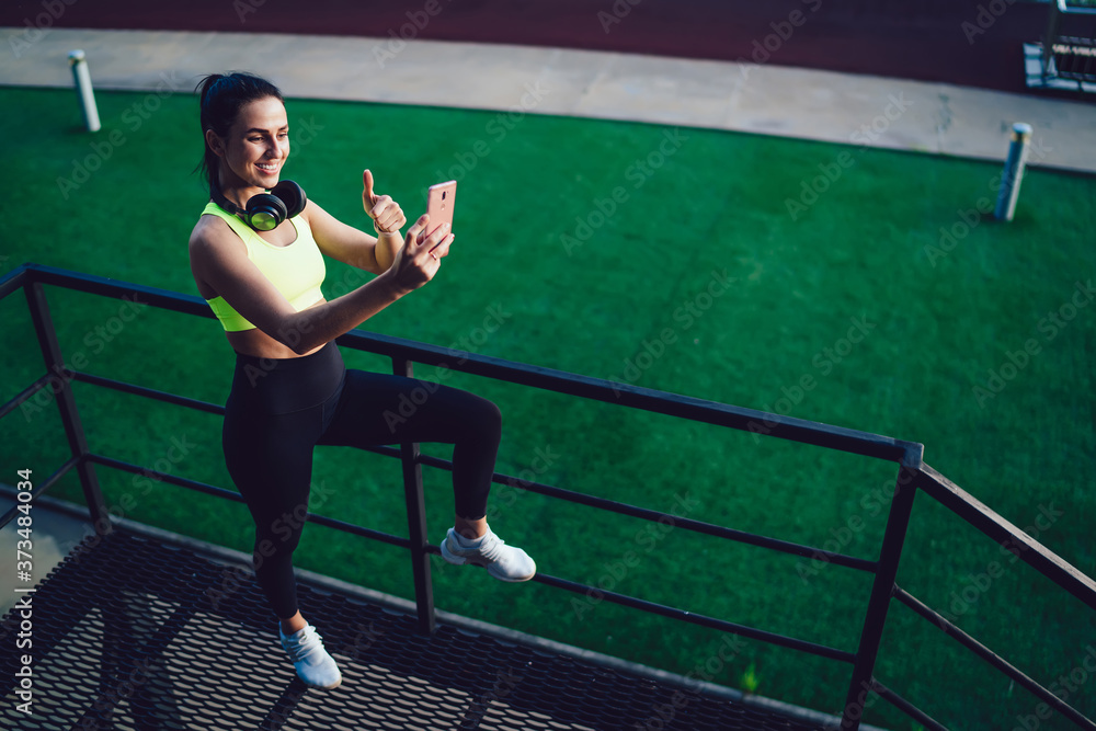Female runner taking selfie on smartphone