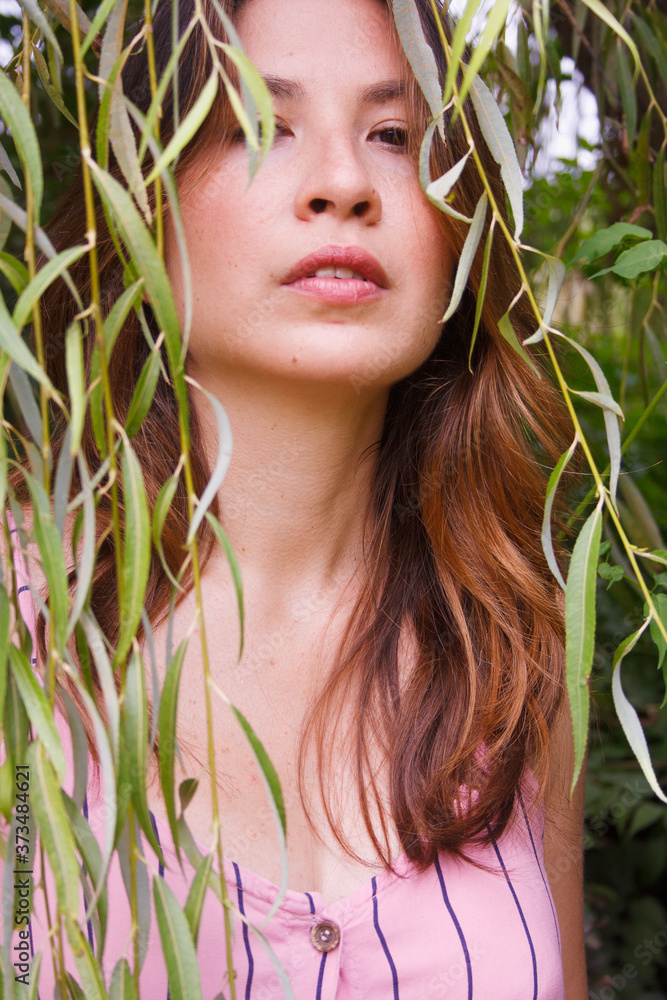 Young woman portrait framed into a willow tree Young woman portrait framed into a willow tree