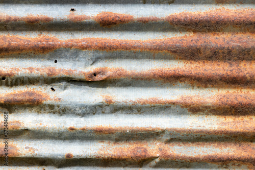 Grunge silver and red rust corrugated iron metal plate textured background