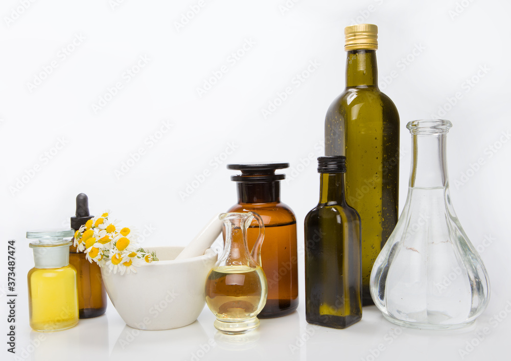 Set bottles of essential oil, white background. Healthy cosmetics concept. Set bottles of essential oil, white background. Healthy cosmetics concept.