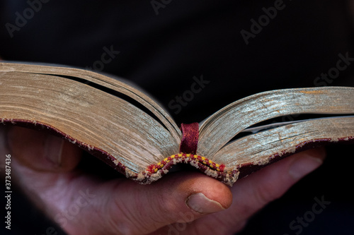 Old hands holding Bible