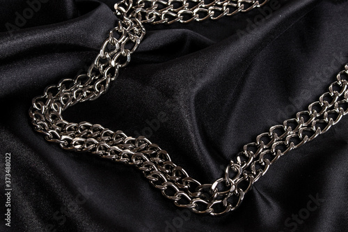 luxury black wavy silk texture with frame of chain background