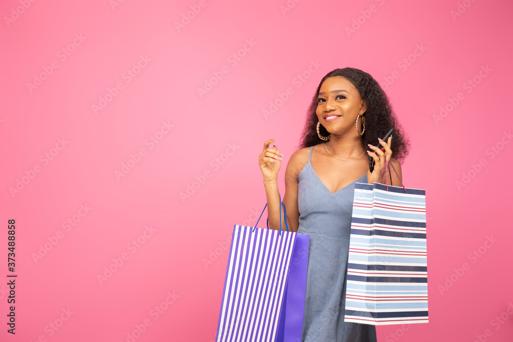 pretty lady carrying some shopping bags smiling pretty lady carrying some shopping bags smiling