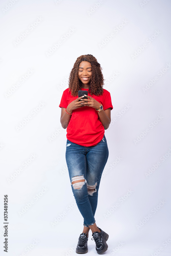 young beautiful black lady using at her phone and smiling young beautiful black lady using at her phone and smiling
