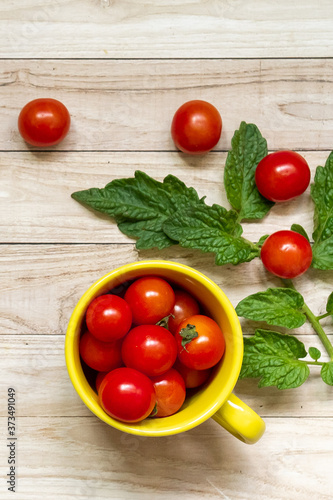 cherry tomatoes on wooden table background