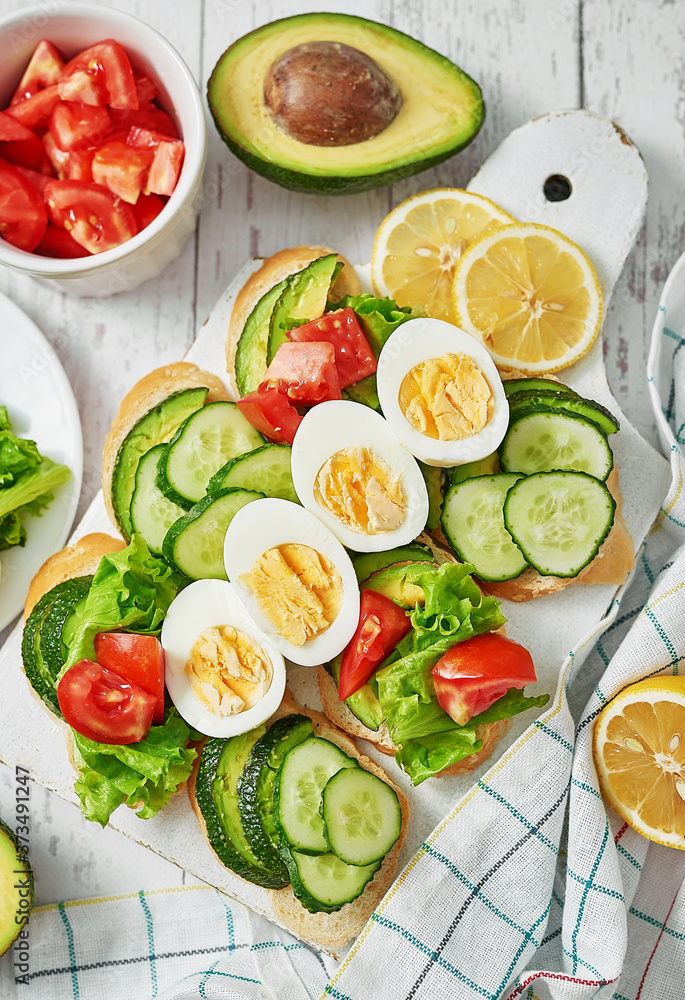 Grain bread sandwiches for breakfast, snacks toasts avocados, eggs, tomatoes, cucumbers. Keto diet. Healthy eating and food, dieting, vegan vegetarian, cleansing. Delicious breakfast or lunch