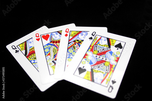 Four Queens in a row - Playing Cards, Isolated on black