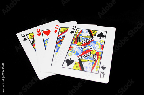 Four Queens in a row - Playing Cards, Isolated on black