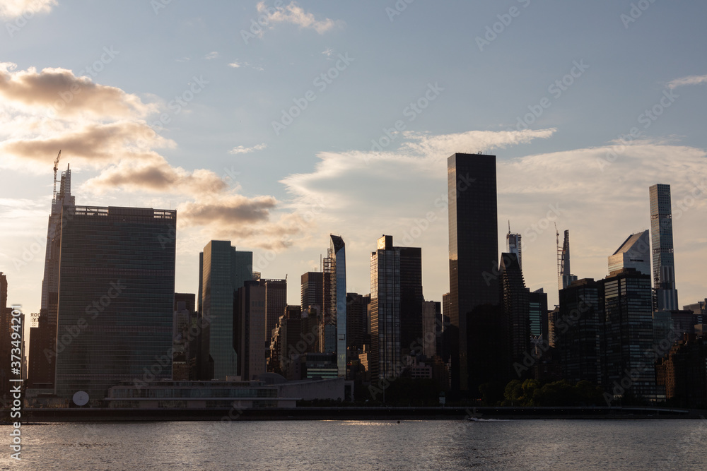 Midtown Manhattan Skyline during a Sunset over the East River in New York City Midtown Manhattan Skyline during a Sunset over the East River in New York City