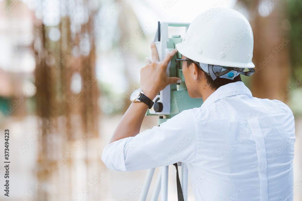 Engineer surveyor working with theodolite at new construction project. Construction worker concept Engineer surveyor working with theodolite at new construction project. Construction worker concept