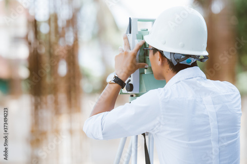 Engineer surveyor working with theodolite at new construction project. Construction worker concept