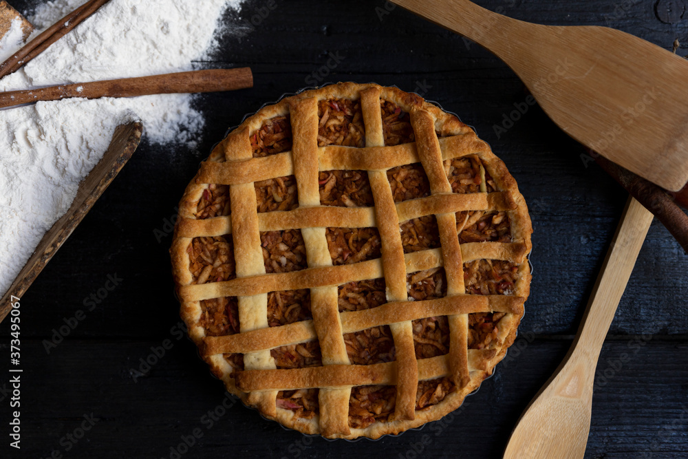 Homemade lattice Apple pie with cinnamon on an old textured wooden background. Top view Homemade lattice Apple pie with cinnamon on an old textured wooden background. Top view