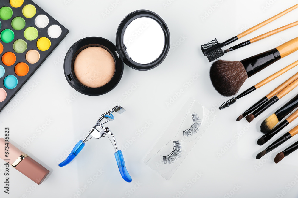 colorful cosmetic background with make up brushes and products colorful cosmetic background with make up brushes and products