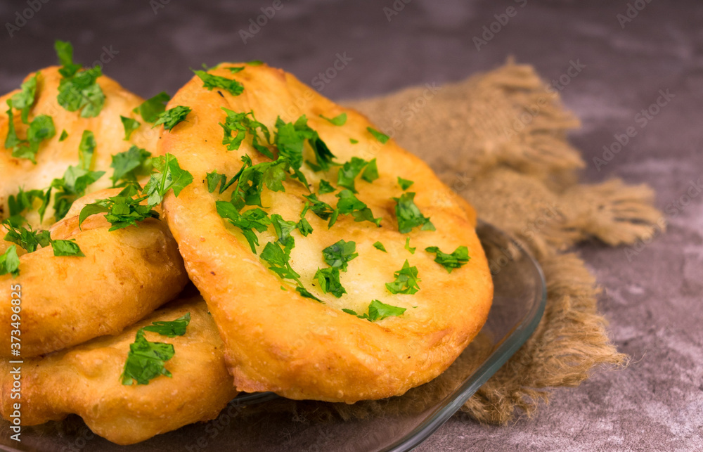 Fried pies with meat on a gray background.
Close-up.