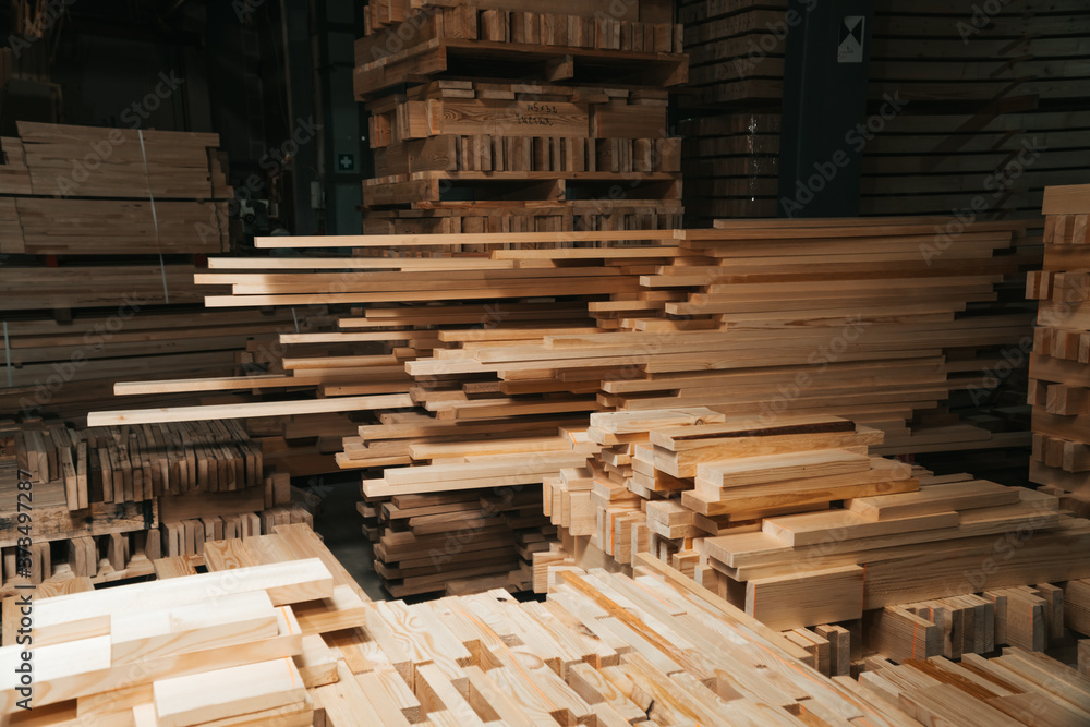 Pine sawn timber processed in a construction workshop. Concept of folded stacked timber. Pine sawn timber processed in a construction workshop. Concept of folded stacked timber.