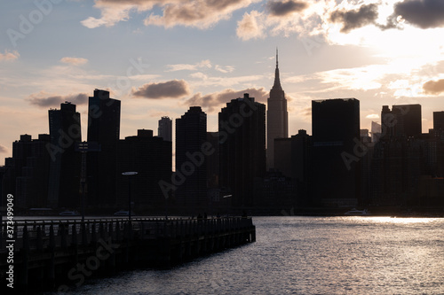 Silhouettes of Skyscrapers in the Midtown Manhattan Skyline seen from Gantry Plaza State Park in Long Island City Queens during a Beautiful Sunset along the East River