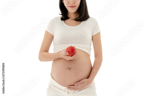 Asian Pregnant Woman Standing Holding Apple in Hand on White Background
