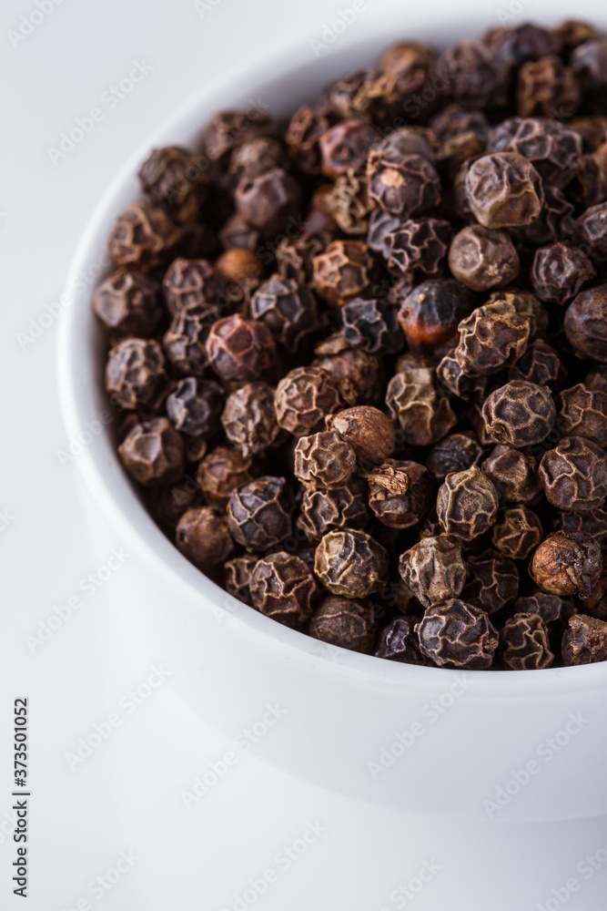 fragrant black pepper on white acrylic background fragrant black pepper on white acrylic background