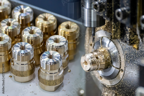 Fotografie The  abstract scene multi-tasking CNC lathe machine swiss type and pipe connector parts