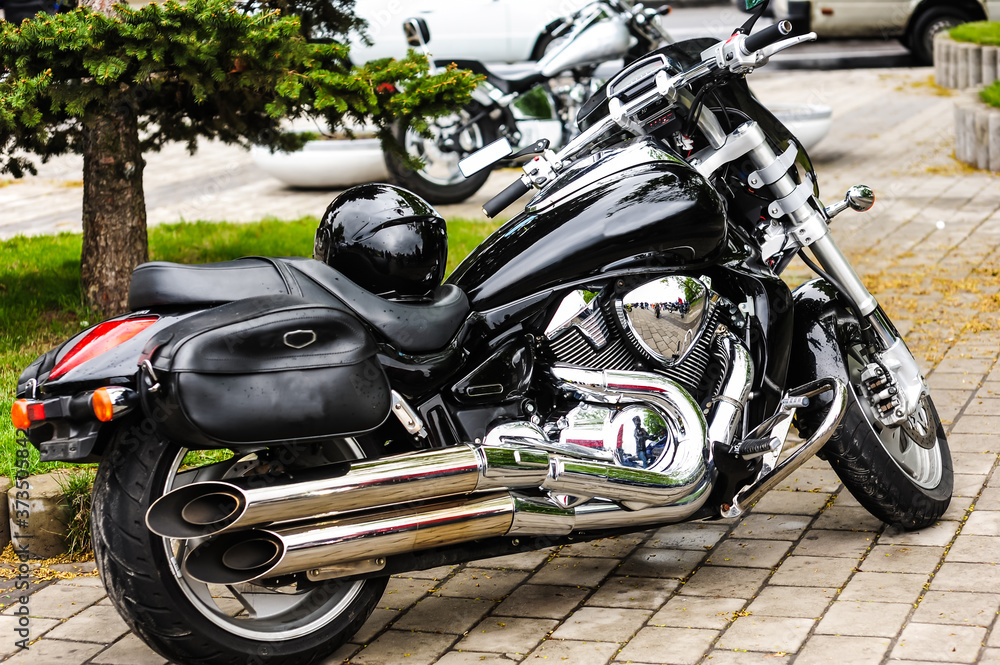 glossy black motorcycle with raindrops.chrome and gloss