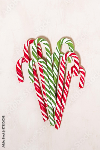 assortment of christmas sugar candies on white wooden background