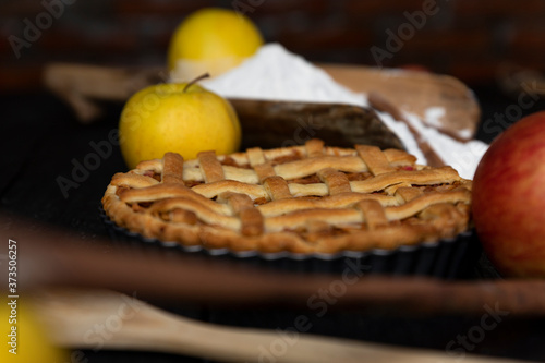 Homemade lattice Apple pie with cinnamon on an old textured wooden background