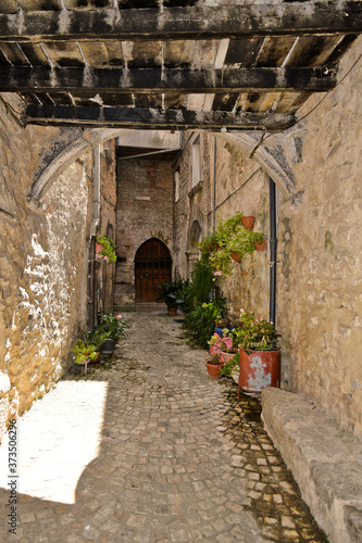 Fototapeta Naklejka Na Ścianę i Meble -  A narrow street among the old houses of Vallecorsa, a medieval village in the lazio region.