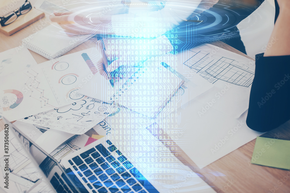 Double exposure of woman's writing hand on background with data technology hud. Big data concept.