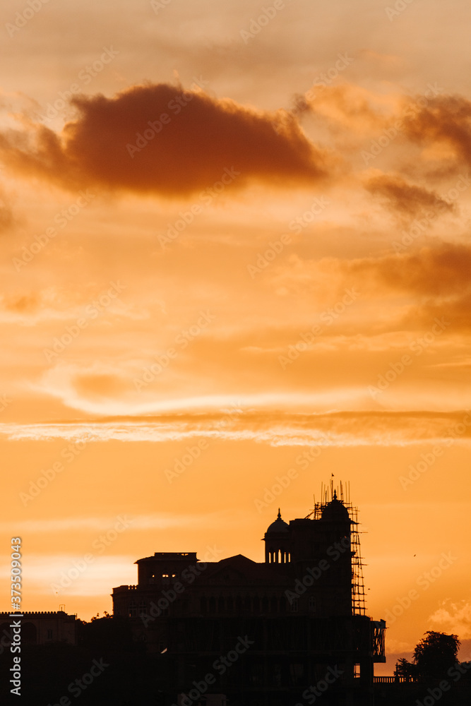View of the beautiful clouds above the building during the sunset View of the beautiful clouds above the building during the sunset