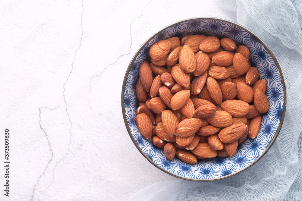 Close up of almond nuts in a bowl on table Close up of almond nuts in a bowl on table