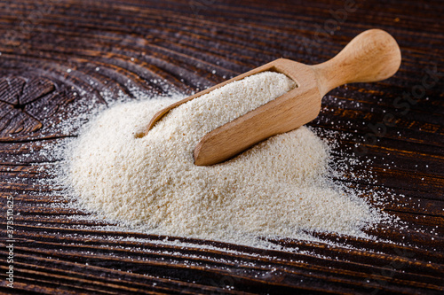 natural organic semolina on dark wooden rustic background