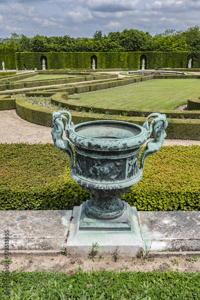 Beautiful Antique Bronze Vases in Gardens of Versailles palace. Royal Versailles palace and surrounding gardens are on the UNESCO World Heritage List. Versailles, Paris, France.