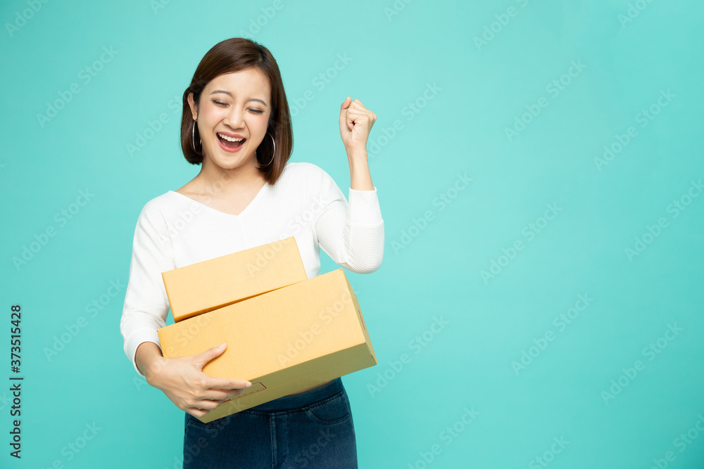 Happy Asian woman holding package parcel box, Delivery courier and shipment service concept Happy Asian woman holding package parcel box, Delivery courier and shipment service concept