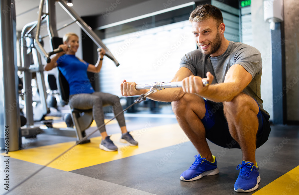 Portrait of fit handsome man workout on a fitness machine at gym Portrait of fit handsome man workout on a fitness machine at gym