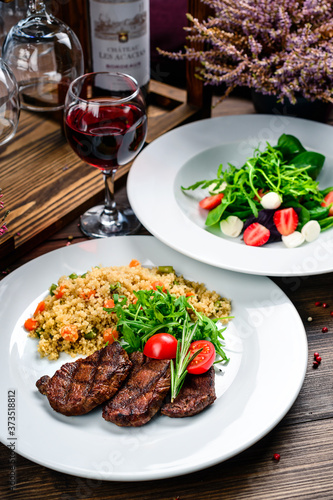 two course lunch grilled meat and fresh vegetable salad on the table