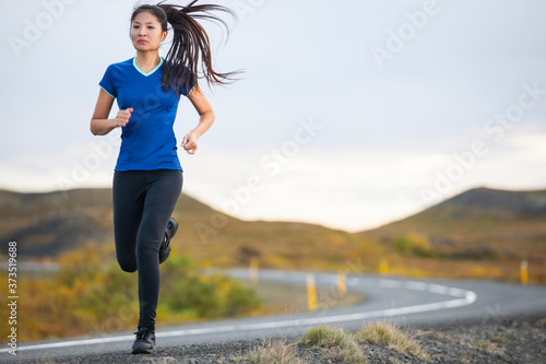 beautiful woman jogging in rural area in Iceland