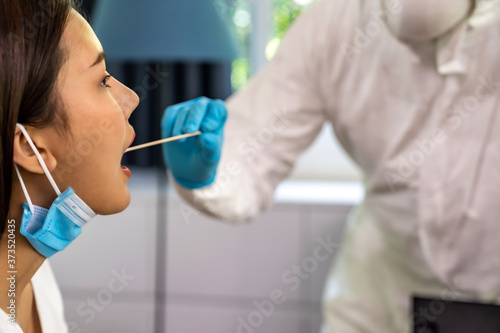 Medicla staff do COVID-19 testing throat swab at home