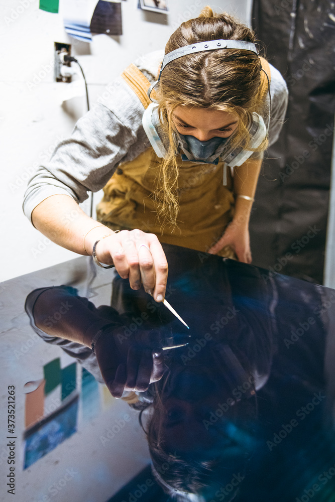Female resin artist using simple materials to perfect artwork Female resin artist using simple materials to perfect artwork