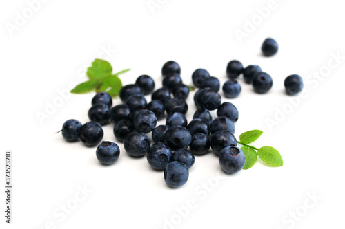 a handful of wild berries on a white table, blueberries