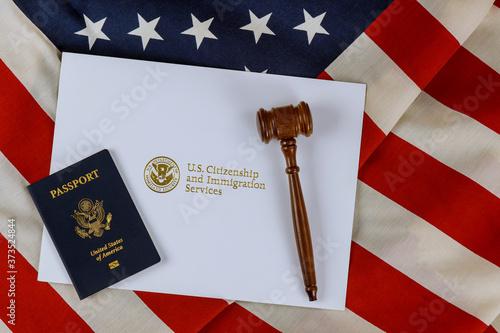 judge's gavel, lawyers office deportation U.S. Citizenship and Immigration Services of naturalization with USA passport over U.S. flag