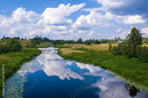 Landscape with beautiful cumulus clouds reflecting in the Teza river, Ivanovo region. photo