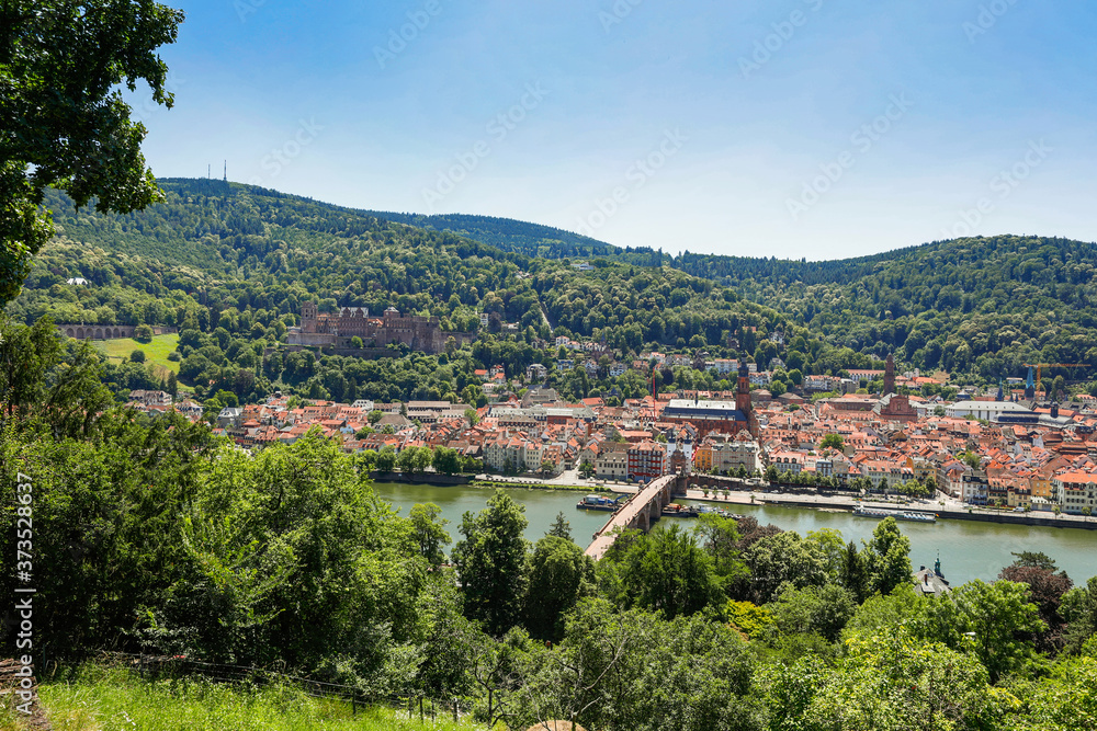 Panoramic view of the old town of Heidelberg with famous Heidelberg Castle on a beautiful sunny day with blue sky and clouds in springtime, Baden-Wuerttemberg, Germany