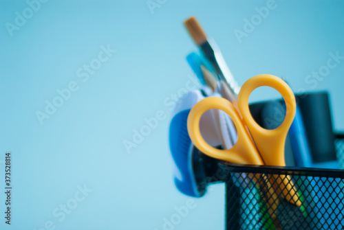 School supplies in an organizer for pencils and pens. Back to school. Place for your text. Stationery.