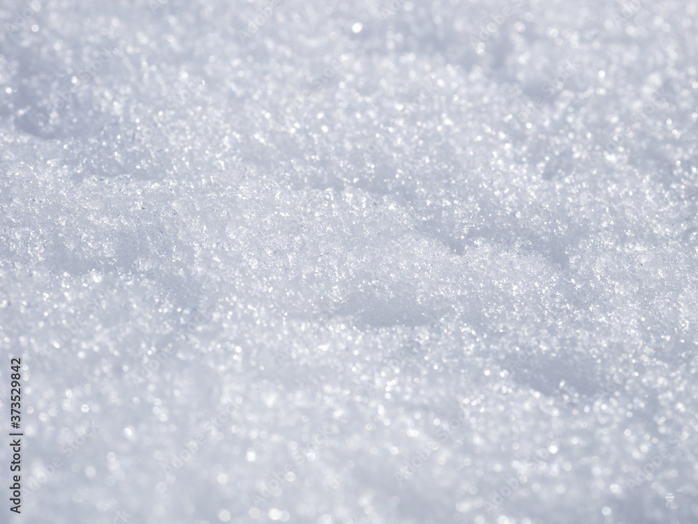 Selective focus. Winter natural texture background with white snow