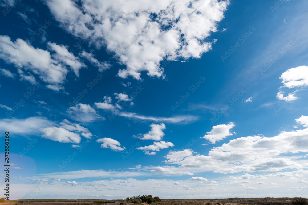 Clear sky in daytime, worm and fluffy clouds, sunny day, spring time Clear sky in daytime, worm and fluffy clouds, sunny day, spring time