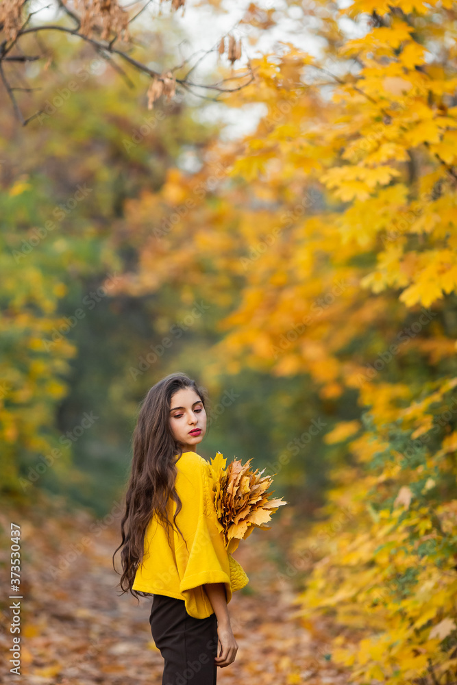 Cheerful woman portrait with autumn maple leaves in the park Cheerful woman portrait with autumn maple leaves in the park